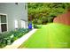Spacious backyard with lush lawn and privacy, next to a well-maintained home exterior at 7170 Kenyon Dr, Denver, NC 28037