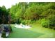 Backyard lounge area featuring string lights, a fire pit, and plenty of space for outdoor enjoyment at 7170 Kenyon Dr, Denver, NC 28037
