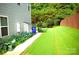 Spacious backyard with a lush lawn and mature trees, offering privacy and tranquility at 7170 Kenyon Dr, Denver, NC 28037