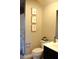 Well-maintained bathroom with neutral colors, decorative artwork, and essential fixtures at 7170 Kenyon Dr, Denver, NC 28037