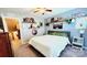 Bedroom showcases a neatly made bed, colorful wall decor, and shelves perfect for displaying collectibles at 7170 Kenyon Dr, Denver, NC 28037