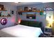This is a bedroom with neutral paint, a large window, and shelves with Marvel and sports decor at 7170 Kenyon Dr, Denver, NC 28037