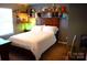 Cozy bedroom featuring sports decor, shelves, and a comfortable bed in a well-lit space at 7170 Kenyon Dr, Denver, NC 28037