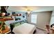 Well-lit bedroom featuring decor shelves, neutral wall color, ceiling fan, and soft, patterned carpeting at 7170 Kenyon Dr, Denver, NC 28037