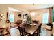 Bright dining room with chandelier, an extra large dining table, and views to a cozy sitting area at 7170 Kenyon Dr, Denver, NC 28037