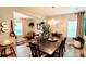 Bright dining room with chandelier and ample seating at 7170 Kenyon Dr, Denver, NC 28037