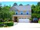 Charming two-story home with a two-car garage, lush landscaping, and a well-manicured lawn at 7170 Kenyon Dr, Denver, NC 28037