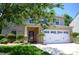 Charming home exterior showcasing brick accents, lush landscaping, and a well-manicured lawn at 7170 Kenyon Dr, Denver, NC 28037