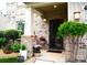 Inviting front porch with brick accents, potted plants, and a stylish front door at 7170 Kenyon Dr, Denver, NC 28037