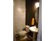 Charming half bath with a stylish vanity, decorative mirror, and unique wallpaper at 7170 Kenyon Dr, Denver, NC 28037