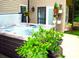 Relaxing hot tub surrounded by lush greenery, potted plants, and a charming outdoor setting at 7170 Kenyon Dr, Denver, NC 28037