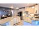 Modern kitchen featuring granite countertops, stainless steel appliances, and a spacious island with seating at 7170 Kenyon Dr, Denver, NC 28037