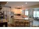 Open concept kitchen with stainless steel appliances, granite counters, and bar seating for casual dining at 7170 Kenyon Dr, Denver, NC 28037