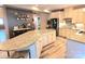 Modern kitchen featuring granite countertops, stainless steel appliances, and a spacious island with seating at 7170 Kenyon Dr, Denver, NC 28037