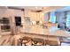 Modern kitchen with granite countertops, stainless steel appliances, and a breakfast bar at 7170 Kenyon Dr, Denver, NC 28037