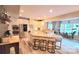 Bright, open-concept kitchen with a large island, stainless steel appliances, and a sunlit dining area at 7170 Kenyon Dr, Denver, NC 28037