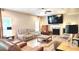 Comfortable living room featuring a fireplace, ceiling fan, and wood flooring at 7170 Kenyon Dr, Denver, NC 28037