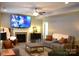 Warm living room featuring a fireplace, comfortable seating, and a stylish entertainment center for media enjoyment at 7170 Kenyon Dr, Denver, NC 28037