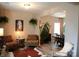 Cozy living room features unique décor, stylish chairs, hardwood floors, and an open layout to the dining area at 7170 Kenyon Dr, Denver, NC 28037