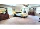 Spacious primary bedroom with ample natural light, decorative tapestry, and and dressers at 7170 Kenyon Dr, Denver, NC 28037