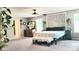 This main bedroom with bright natural light, carpeted floors, and a large mandala wall art at 7170 Kenyon Dr, Denver, NC 28037