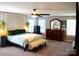 Spacious main bedroom with a decorative headboard, ceiling fan, and a dresser at 7170 Kenyon Dr, Denver, NC 28037