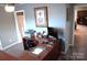 Well-lit home office features a spacious desk, neutral paint, and a view into an adjacent room at 7170 Kenyon Dr, Denver, NC 28037