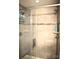 Walk-in shower features tiled walls, mosaic accents, and a sleek glass door for a spa-like experience at 7170 Kenyon Dr, Denver, NC 28037