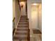 Staircase featuring wood railing, carpeted steps, and natural light at 7170 Kenyon Dr, Denver, NC 28037