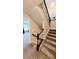 Carpeted staircase with stained railing and a glimpse into a comfortably furnished living space at 7170 Kenyon Dr, Denver, NC 28037
