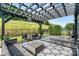 Backyard patio area featuring dark pergola with outdoor dining and seating and grass area at 7809 Creek Park Dr, Denver, NC 28037