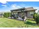Backyard with patio featuring dark pergola with outdoor dining and seating and green grass at 7809 Creek Park Dr, Denver, NC 28037