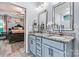 Bathroom featuring a granite countertop, double sinks, vanity mirrors and access to the main bedroom at 7809 Creek Park Dr, Denver, NC 28037