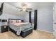 Comfortable bedroom features neutral walls, carpet, a ceiling fan and a window at 7809 Creek Park Dr, Denver, NC 28037