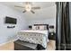 Comfortable bedroom with neutral walls, carpet, ceiling fan, and mounted TV at 7809 Creek Park Dr, Denver, NC 28037
