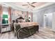 Luxurious bedroom with tray ceilings, hardwood floors, natural light, and an accent wall at 7809 Creek Park Dr, Denver, NC 28037
