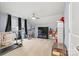 Spacious bonus room with exercise equipment, a ceiling fan, and natural light from the window at 7809 Creek Park Dr, Denver, NC 28037