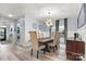 Formal dining room features a modern chandelier and large windows that provide natural light at 7809 Creek Park Dr, Denver, NC 28037