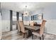 Spacious dining room featuring wainscotting, modern chandelier and large windows for natural light at 7809 Creek Park Dr, Denver, NC 28037
