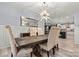 Dining room boasts a large table, chandelier, and view into the kitchen at 7809 Creek Park Dr, Denver, NC 28037
