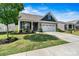 Beautiful home featuring manicured lawn, gray siding, a two-car garage, and welcoming front porch at 7809 Creek Park Dr, Denver, NC 28037