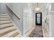 Inviting foyer featuring a modern chandelier and stairs leading to the upper level at 7809 Creek Park Dr, Denver, NC 28037