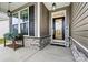 Charming front porch with stone accents, black shutters, and a welcoming entrance door at 7809 Creek Park Dr, Denver, NC 28037