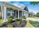 Inviting front porch with manicured landscaping and stone accents adding curb appeal at 7809 Creek Park Dr, Denver, NC 28037