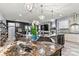 Open kitchen view, seamlessly connecting to the living room, with granite counters and modern appliances at 7809 Creek Park Dr, Denver, NC 28037