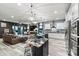 Open kitchen with a large island, modern lighting, and seamless integration with the living area at 7809 Creek Park Dr, Denver, NC 28037