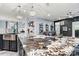 Open-concept kitchen featuring a large island with marble countertops and modern pendant lighting at 7809 Creek Park Dr, Denver, NC 28037