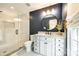 Modern bathroom featuring a granite vanity, a stylish mirror, modern fixtures, and a glass-enclosed tiled shower at 815 Granby Dr, Fort Mill, SC 29708