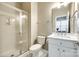 Well-lit bathroom features a tiled shower, white vanity, and decorative mirror at 815 Granby Dr, Fort Mill, SC 29708