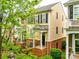 Charming exterior view of a townhome featuring brick accents, landscaped front yard, and a welcoming entrance at 815 Granby Dr, Fort Mill, SC 29708